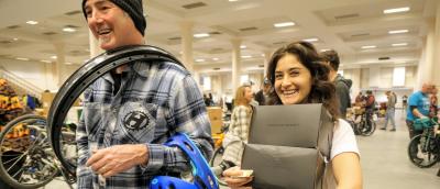 Two shoppers smile as they carry off their great finds!